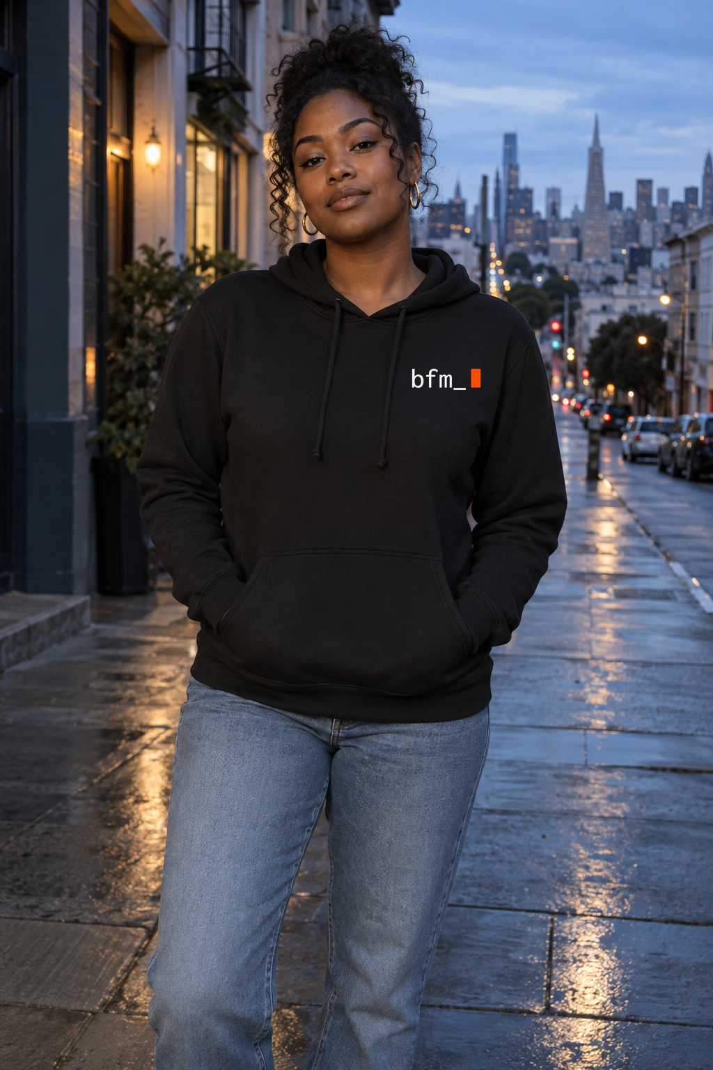 BFM ORIGIN LATENT v2 — Bella Canvas 7519 Black, front. AI-generated editorial image; not a photograph of the physical product.